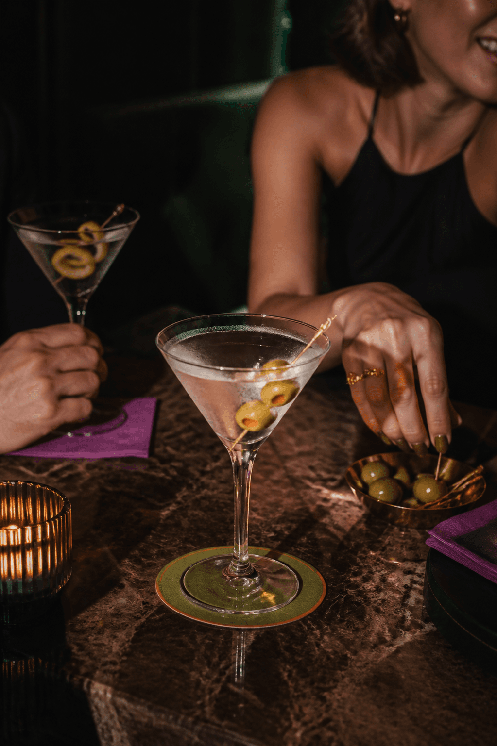 Friends comparing Martinis around a cocktail table